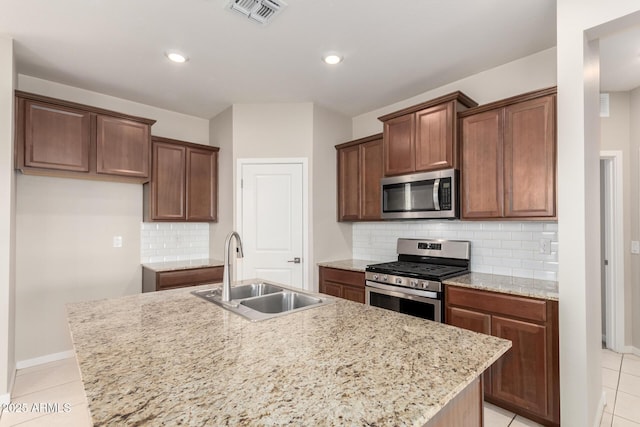 14355 W Valentine St, Surprise, AZ 85379 - kitchen featuring visible vents, a center island with sink, a sink, appliances with stainless steel finishes, and light tile patterned floors