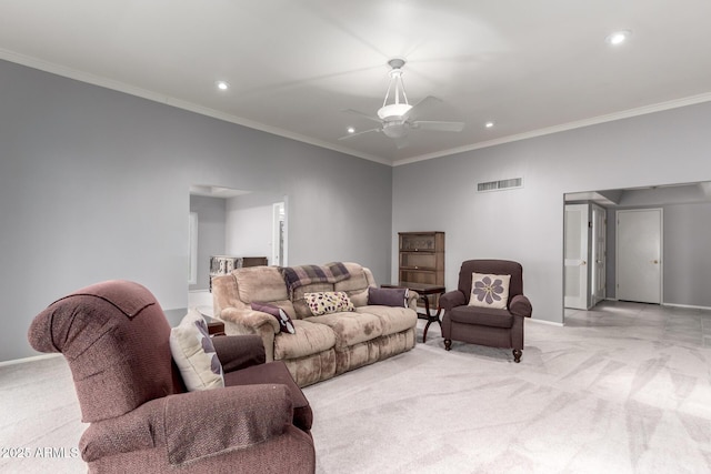 living area featuring ceiling fan, light colored carpet, visible vents, baseboards, and ornamental molding