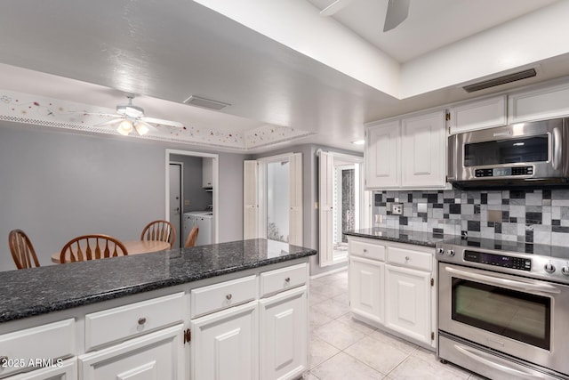 kitchen featuring ceiling fan, appliances with stainless steel finishes, backsplash, and washer and dryer