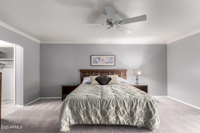 carpeted bedroom featuring ornamental molding, baseboards, and a ceiling fan