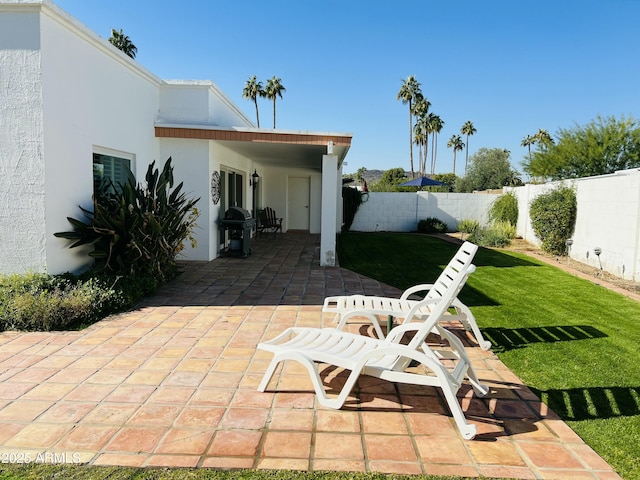 view of patio with a fenced backyard and a grill