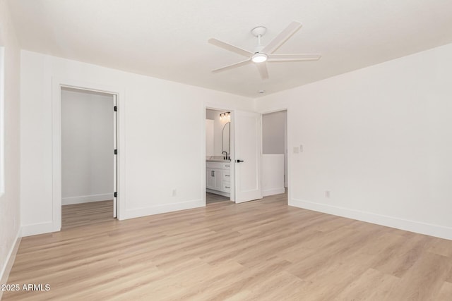 5736 E Singletree St, Apache Junction, AZ 85119 - unfurnished bedroom featuring light wood-style flooring, a walk in closet, ensuite bath, and a ceiling fan