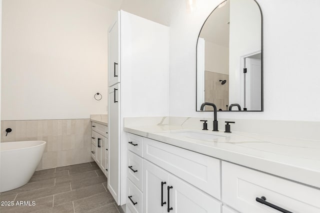 5736 E Singletree St, Apache Junction, AZ 85119 - bathroom featuring vanity, tile walls, a freestanding bath, a wainscoted wall, and tiled shower