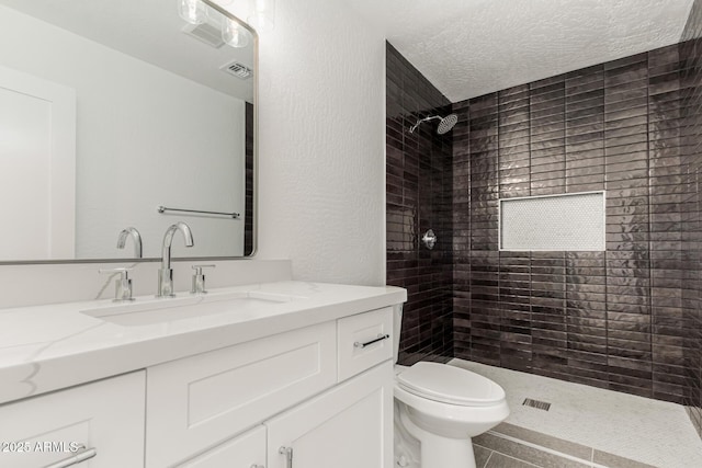 5736 E Singletree St, Apache Junction, AZ 85119 - full bath with vanity, tiled shower, tile patterned flooring, and a textured ceiling