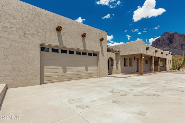 5736 E Singletree St, Apache Junction, AZ 85119 - pueblo-style home featuring concrete driveway, stucco siding, and a garage
