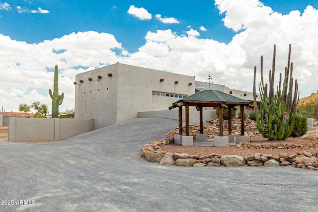 5736 E Singletree St, Apache Junction, AZ 85119 - view of building exterior featuring asphalt driveway and an attached garage