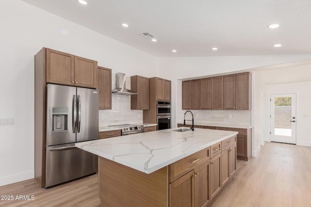 5736 E Singletree St, Apache Junction, AZ 85119 - kitchen with appliances with stainless steel finishes, wall chimney exhaust hood, vaulted ceiling, light wood-type flooring, and decorative backsplash