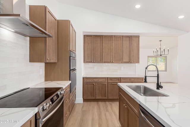 5736 E Singletree St, Apache Junction, AZ 85119 - kitchen with appliances with stainless steel finishes, wall chimney range hood, vaulted ceiling, tasteful backsplash, and brown cabinetry