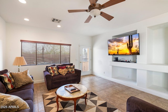 living room featuring built in shelves and ceiling fan