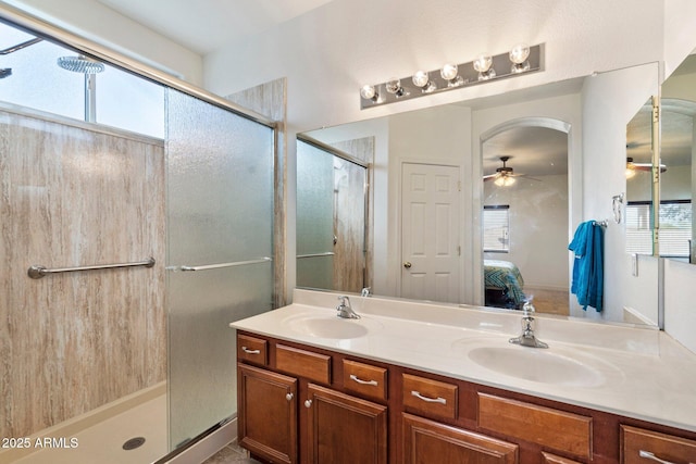 bathroom with an enclosed shower, a wealth of natural light, vanity, and ceiling fan