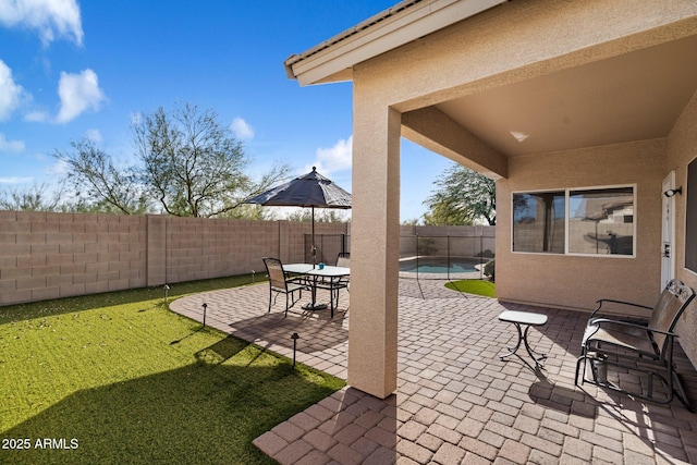 view of patio with a fenced in pool