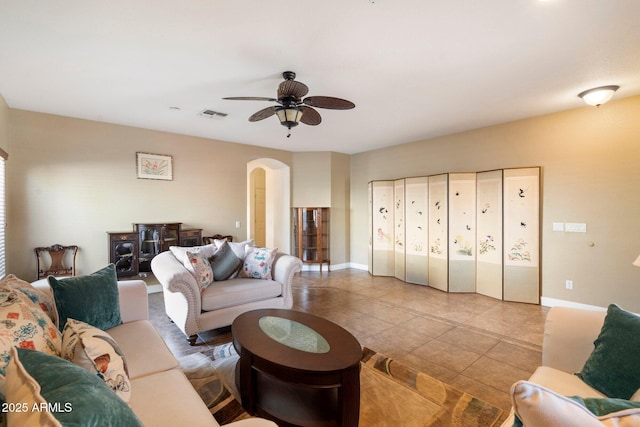 tiled living room with ceiling fan