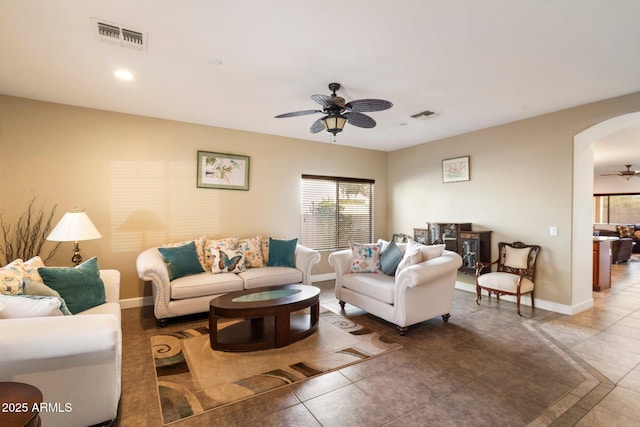 tiled living room featuring ceiling fan