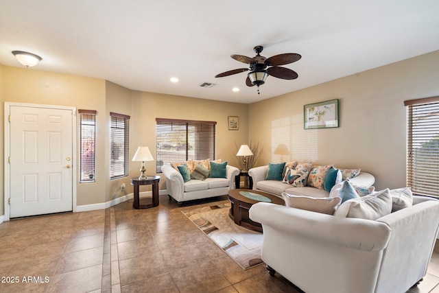 living room featuring ceiling fan, light tile patterned flooring, and a healthy amount of sunlight