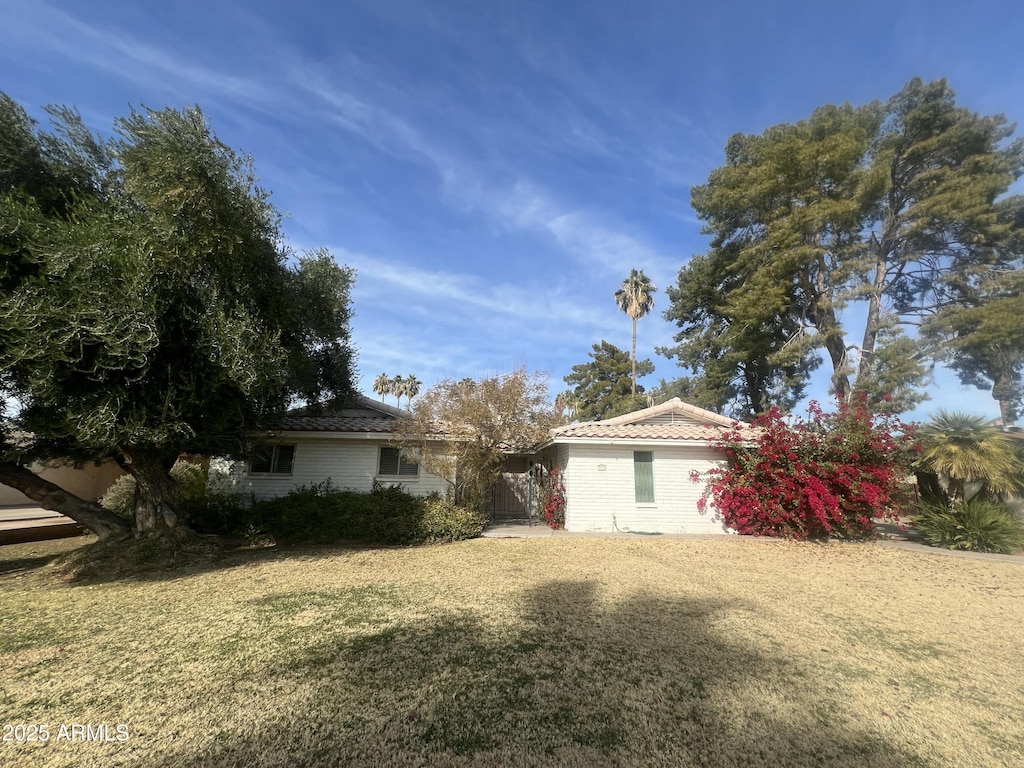 view of property exterior with a lawn