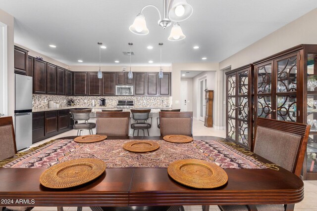 dining space featuring an inviting chandelier and light tile patterned floors