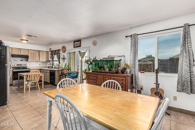 3208 W Wagoner Rd, Phoenix, AZ 85053 - dining space with light tile patterned floors and a textured ceiling