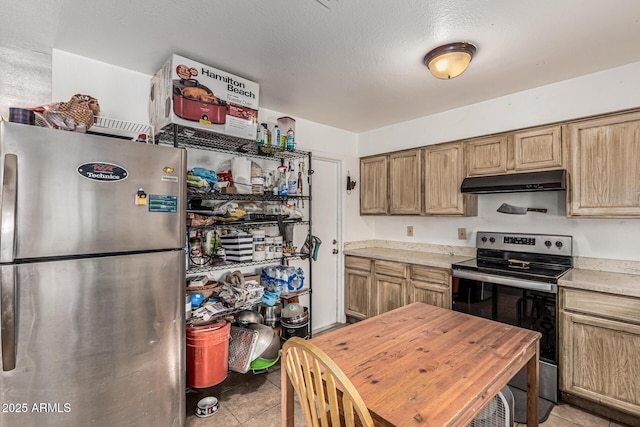 3208 W Wagoner Rd, Phoenix, AZ 85053 - kitchen featuring appliances with stainless steel finishes, under cabinet range hood, light tile patterned floors, and light countertops