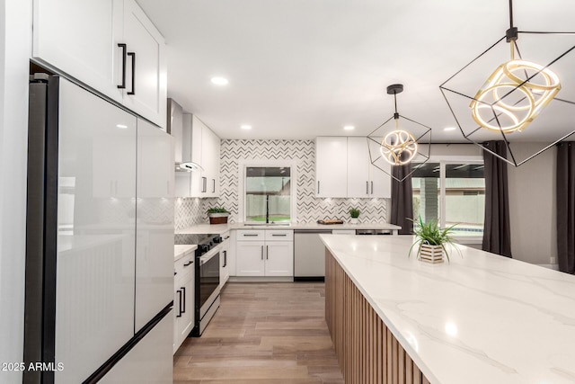 kitchen with dishwashing machine, white cabinets, stainless steel range with electric cooktop, refrigerator with glass door, and plenty of natural light