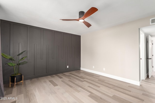 unfurnished bedroom with light wood-style floors, ceiling fan, visible vents, and baseboards