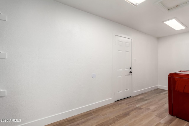 interior space with light wood-type flooring and baseboards