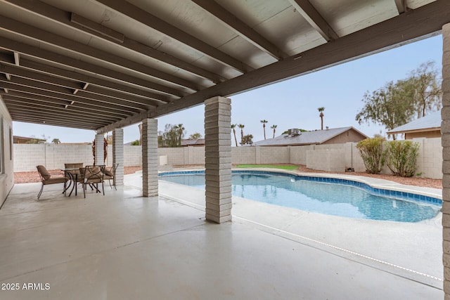 view of swimming pool featuring a patio area, a fenced backyard, a fenced in pool, and outdoor dining space