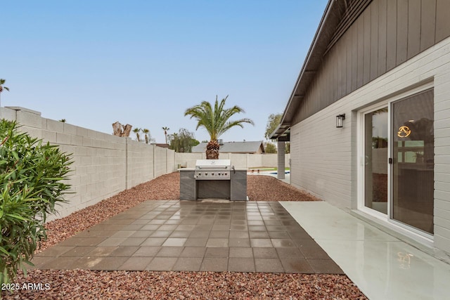 view of patio / terrace featuring a fenced backyard and area for grilling