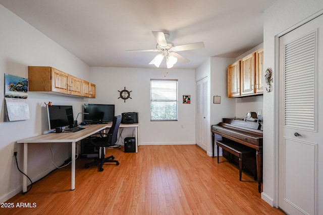 office with baseboards, ceiling fan, and light wood-style floors