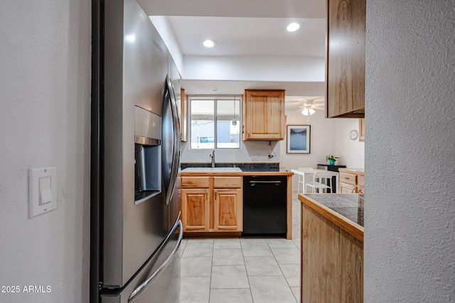 kitchen featuring dishwasher, light tile patterned floors, a sink, and stainless steel fridge