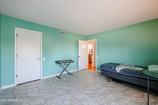 bedroom featuring visible vents and baseboards