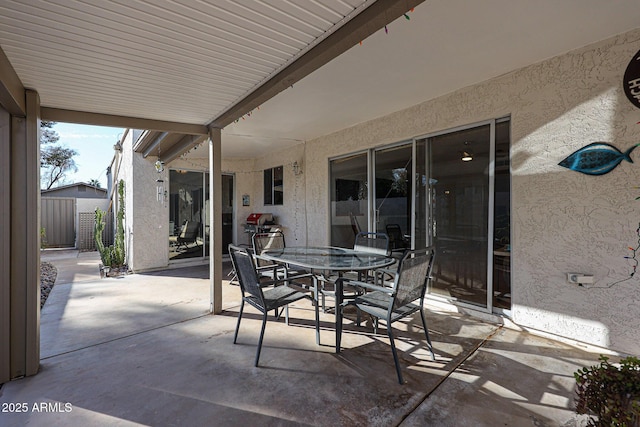 view of patio / terrace with outdoor dining space, fence, and grilling area