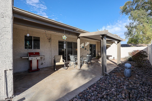 view of patio / terrace with a grill and fence