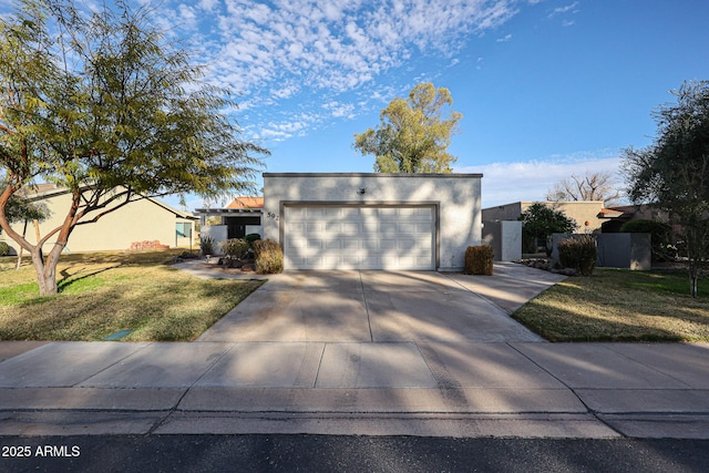 view of front of property with driveway, a front yard, and stucco siding