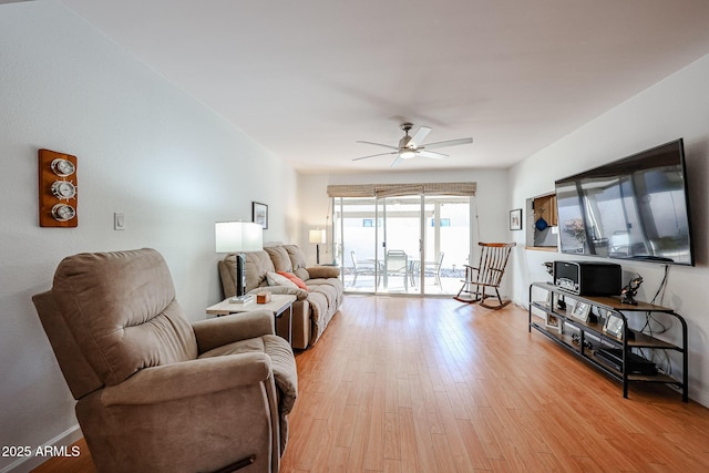 living area with ceiling fan and light wood finished floors