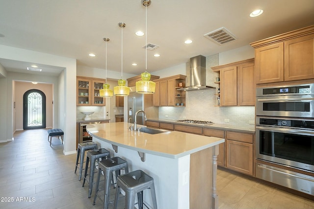 kitchen with open shelves, visible vents, a warming drawer, and wall chimney exhaust hood