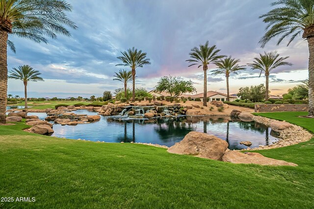 view of water feature with a garden pond