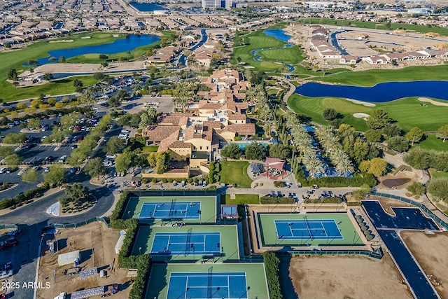 birds eye view of property with golf course view and a water view