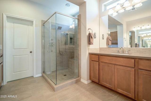 full bath featuring vanity, a shower stall, visible vents, and decorative backsplash