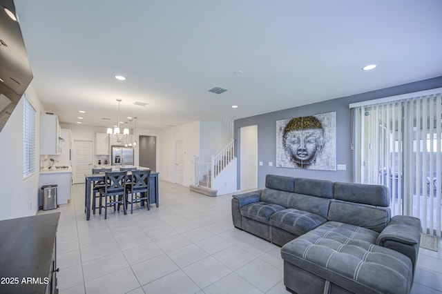 5621 W Chuck Box Rd, Laveen, AZ 85339 - living room featuring a chandelier, light tile patterned floors, recessed lighting, and stairs
