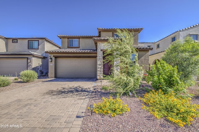 5621 W Chuck Box Rd, Laveen, AZ 85339 - mediterranean / spanish house featuring stucco siding, a garage, a tiled roof, and decorative driveway
