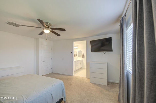5621 W Chuck Box Rd, Laveen, AZ 85339 - bedroom with light carpet, ensuite bathroom, and a ceiling fan