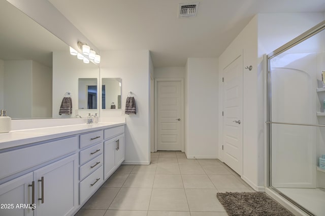 5621 W Chuck Box Rd, Laveen, AZ 85339 - bathroom with double vanity, tile patterned flooring, and an enclosed shower