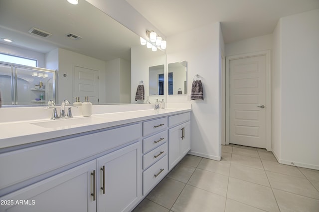 5621 W Chuck Box Rd, Laveen, AZ 85339 - bathroom with double vanity, tile patterned floors, a shower with shower door, and recessed lighting