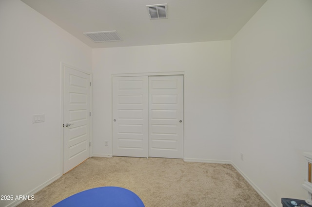 5621 W Chuck Box Rd, Laveen, AZ 85339 - unfurnished bedroom with light carpet and a closet