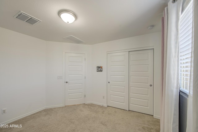 5621 W Chuck Box Rd, Laveen, AZ 85339 - unfurnished bedroom featuring light colored carpet and a closet