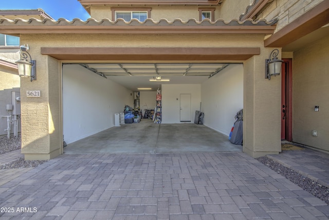 5621 W Chuck Box Rd, Laveen, AZ 85339 - garage with decorative driveway and a garage door opener