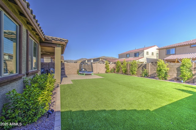 5621 W Chuck Box Rd, Laveen, AZ 85339 - fenced backyard with a trampoline and a residential view