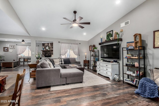 living room with dark wood-type flooring, ceiling fan, and lofted ceiling