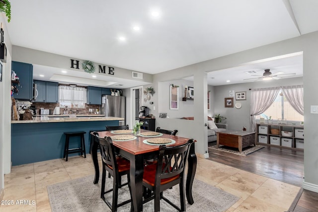 dining room with light tile patterned floors and ceiling fan