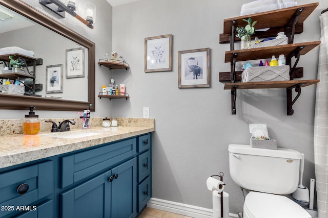 bathroom featuring tile patterned floors, vanity, and toilet